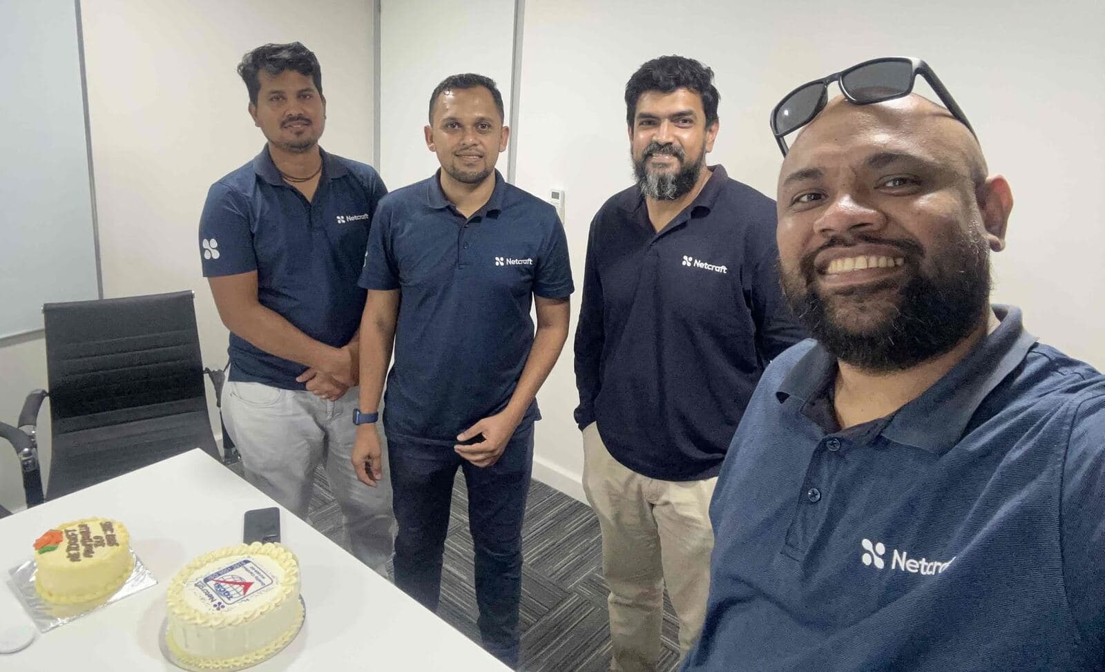 Netcraft's Fiji team celebrating the ISO 9001 certification
with a cake